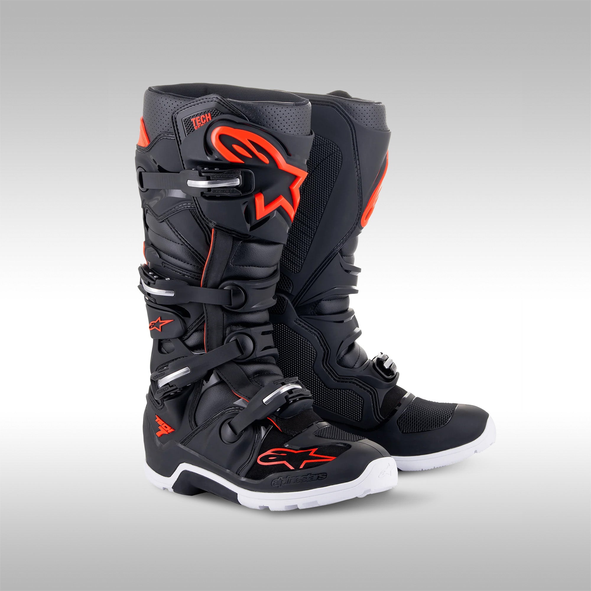 Alpinestars Tech 7 Enduro boots in the Light Gray, Dark Gray with Bright Red accent option. The left and right boot next to each other. Enduro and dualsport motorcycle boots. Protective gear for dirtbike riding.