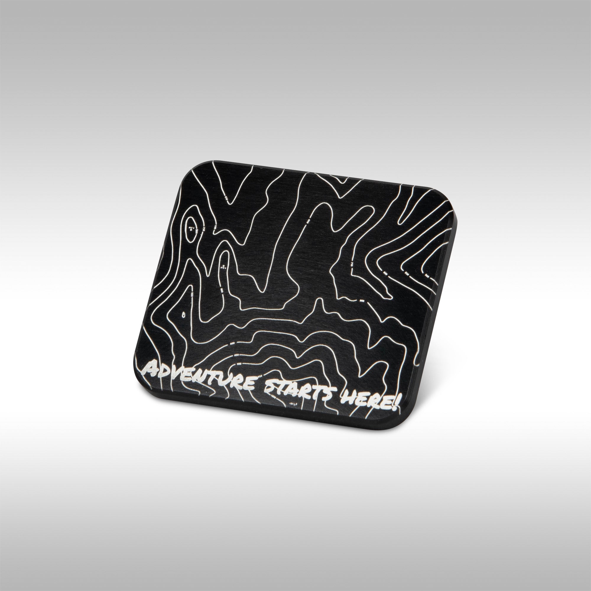 Studio shot of the MotoPumps aluminum gps mount cover with the TOPO design laser etched into it.