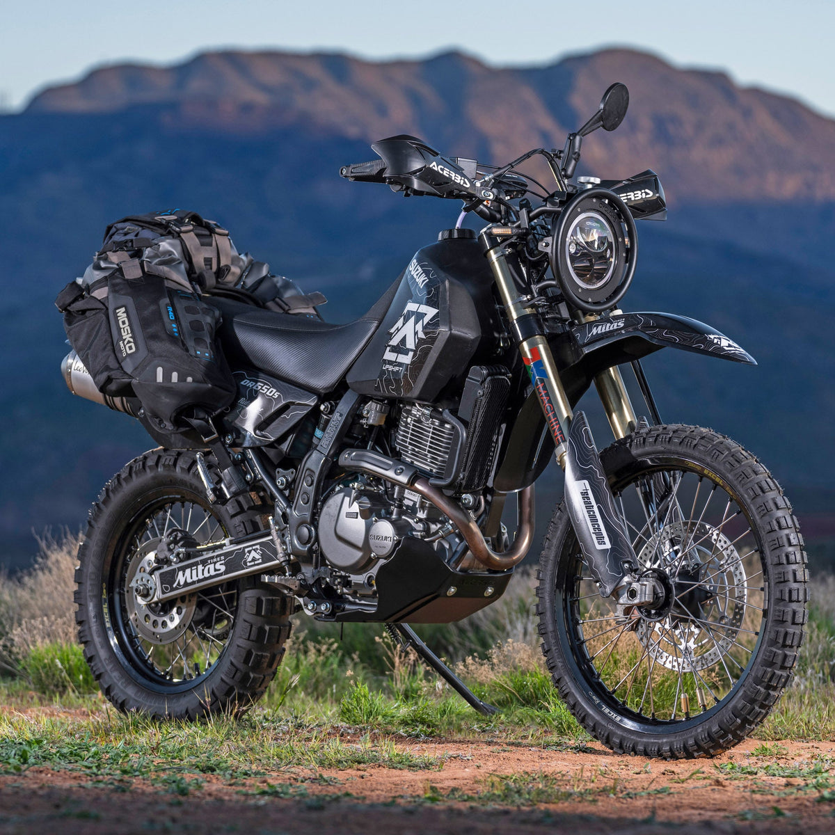 Upshift Online&#39;s 2022 DR650 project bike in the mountains.  Shown with accessories from TMBR MOTO like the Acerbis skid plate, Doubletake Mirrors, Seat Concepts seat and of course and Acerbis 5.3 gallon fuel tank.